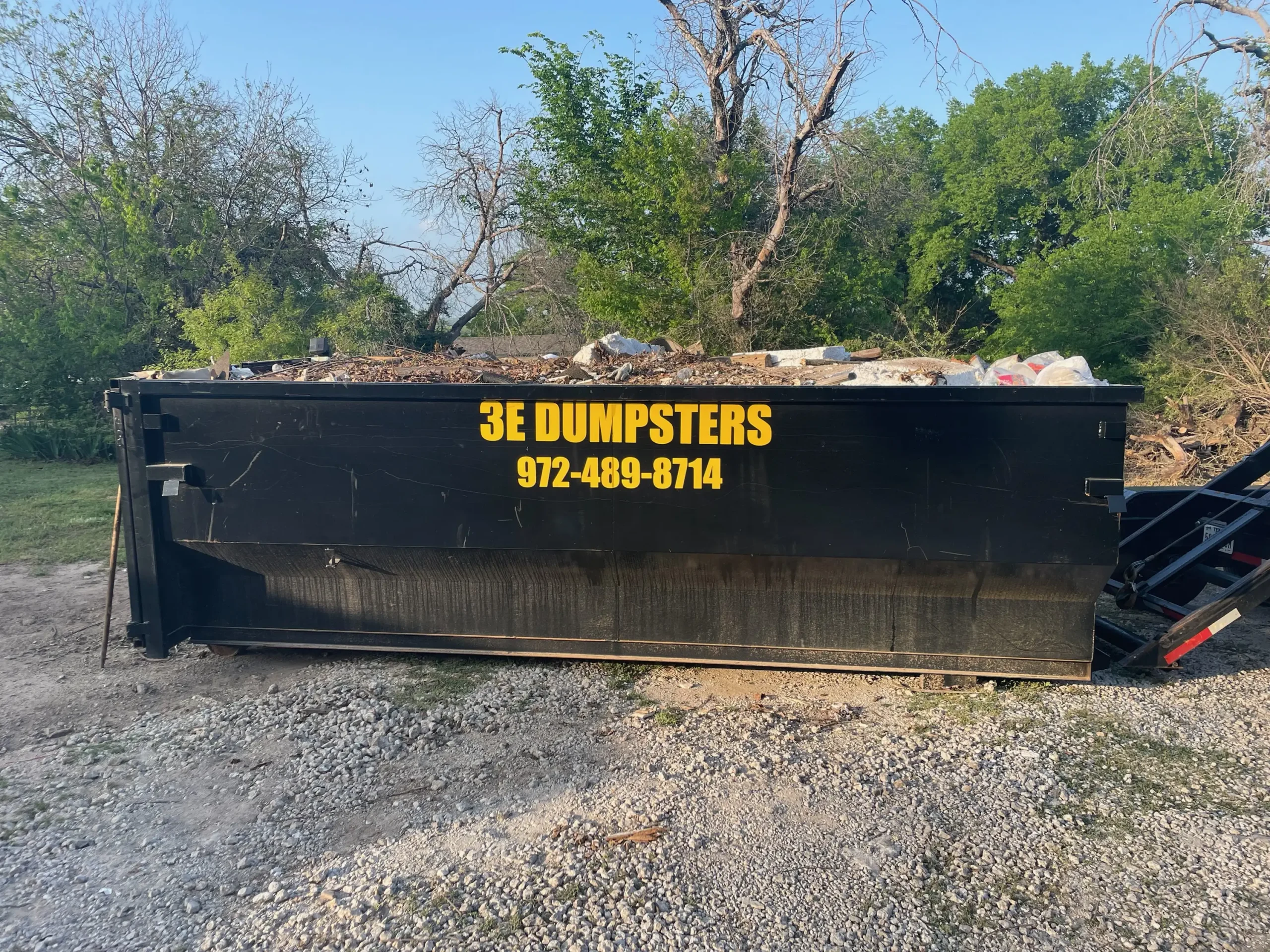3E Dumpsters 20 yard roll-off dumpster filled to capacity at job site in Wise County TX